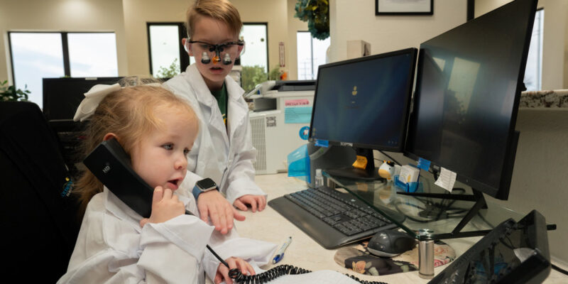 Children Dressed as Dentists at a Reception Desk